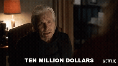 A Man Is Sitting In A Chair With The Words Ten Million Dollars Written On The Screen Behind Him GIF