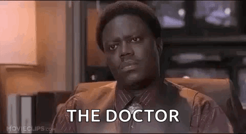 A Man Is Sitting In A Chair With The Words `` The Doctor '' Written On His Face . GIF