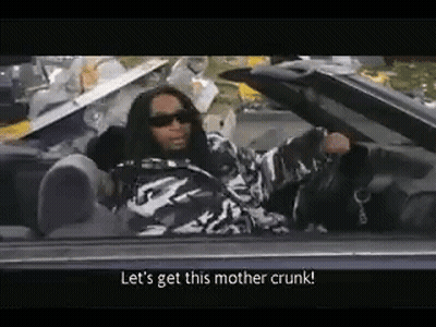 A Man Is Sitting In A Convertible Car Talking To Someone . GIF