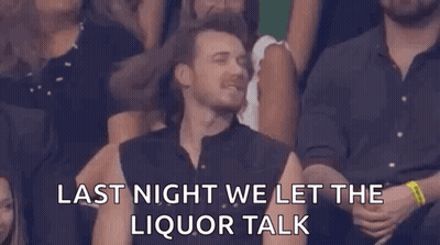 A Man Is Sitting In A Crowd Of People With His Eyes Closed And A Caption That Says `` Last Night We Let The Liquor Talk  GIF