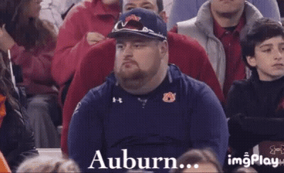 A Man Is Sitting In A Crowd With The Words Letting You Down Written On The Bottom GIF