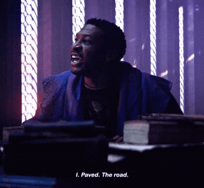 A Man Is Sitting In A Dark Room And Says Paved The Road . GIF
