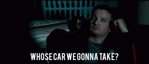 A Man Is Sitting In A Dark Room With The Words `` Whose Car We Gonna Take '' Written On The Bottom . GIF