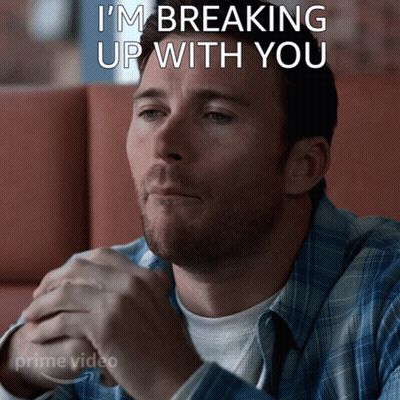 A Man Is Sitting In A Diner With The Words I 'M Breaking Up With You Written Above Him GIF