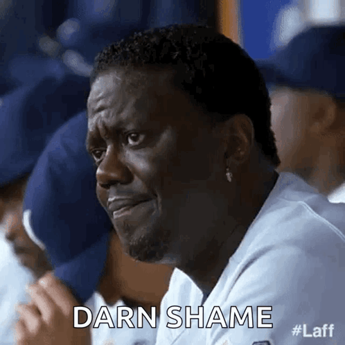 A Man Is Sitting In A Dugout With His Eyes Closed And The Words Darn Shame Written On The Screen . GIF