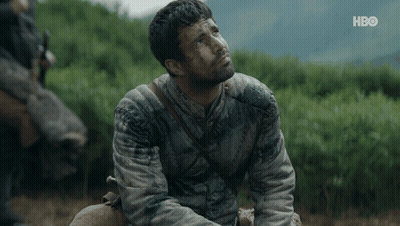 A Man Is Sitting In A Field With A Hbo Logo In The Corner GIF