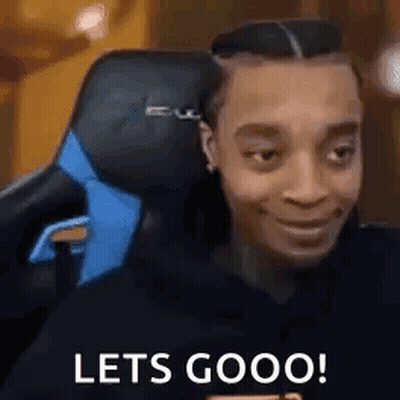A Man Is Sitting In A Gaming Chair With The Words `` Lets Goooo '' Written On His Face . GIF