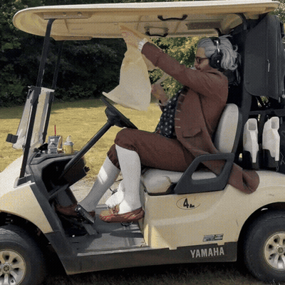 A Man Is Sitting In A Golf Cart That Says Yamaha GIF