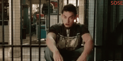 A Man Is Sitting In A Jail Cell With The Word Sose On The Bottom Right GIF