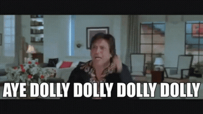 A Man Is Sitting In A Living Room Talking On A Cell Phone And Saying Aye Dolly Dolly Dolly Dolly . GIF