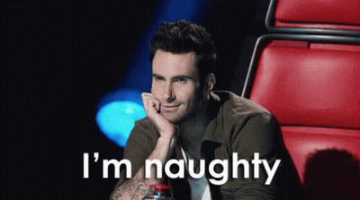 A Man Is Sitting In A Red Chair With His Hand On His Chin And The Words I 'M Naughty Behind Him . GIF