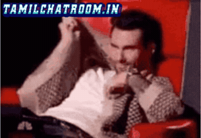 A Man Is Sitting In A Red Chair With The Words Tamilchatroom.in In The Corner GIF