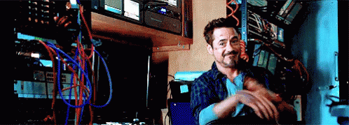 A Man Is Sitting In A Room With A Lot Of Wires And Cables . GIF
