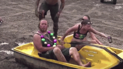 A Man Is Sitting In A Small Yellow Boat With A Woman In The Back GIF