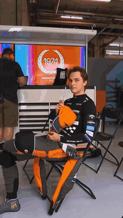 A Man Is Sitting In Front Of A 1974 Sign GIF