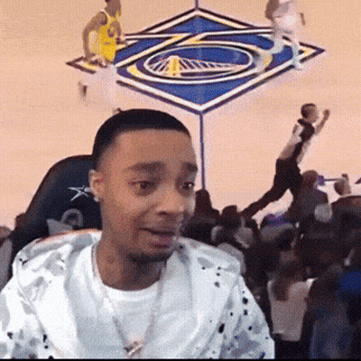 A Man Is Sitting In Front Of A Basketball Court GIF