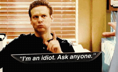 A Man Is Sitting In Front Of A Computer Screen That Says " I 'M An Idiot Ask Anyone " . GIF