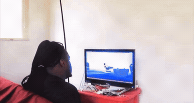 A Man Is Sitting In Front Of A Computer Screen With A Picture Of A Boat On It GIF