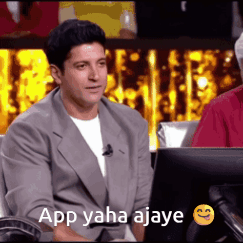A Man Is Sitting In Front Of A Computer With The Words App Yaha Ajay Written On The Screen GIF
