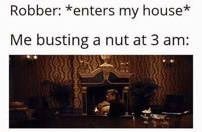A Man Is Sitting In Front Of A Fireplace In A Room With A Statue On The Wall . GIF