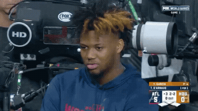 A Man Is Sitting In Front Of A Fox World Series Game GIF