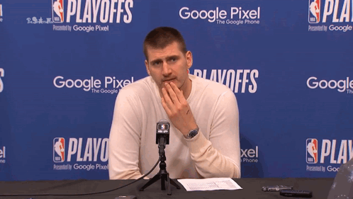 A Man Is Sitting In Front Of A Google Pixel Banner GIF