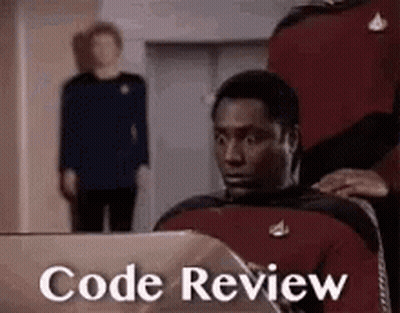 A Man Is Sitting In Front Of A Laptop With The Words `` Code Review '' Written On The Screen . GIF