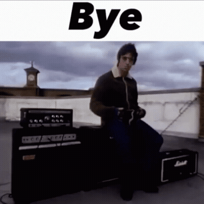A Man Is Sitting In Front Of A Marshall Guitar Amplifier . GIF