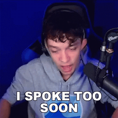 A Man Is Sitting In Front Of A Microphone And Says I Spoke Too Soon . GIF