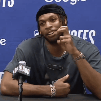 A Man Is Sitting In Front Of A Microphone That Says Nba App GIF