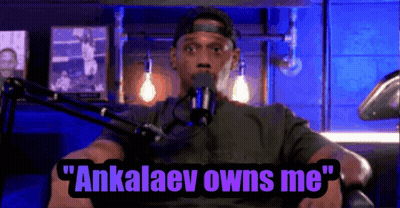 A Man Is Sitting In Front Of A Microphone With The Words " Ankalaev Owns Me " Above Him GIF
