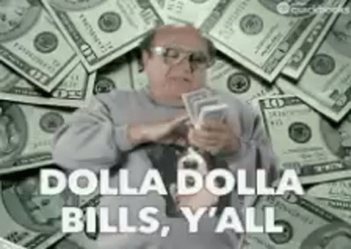 A Man Is Sitting In Front Of A Pile Of Money Holding A Bunch Of Money . GIF