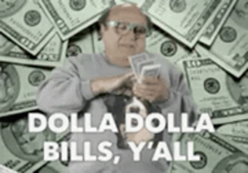 A Man Is Sitting In Front Of A Pile Of Money Holding A Bunch Of Money . GIF
