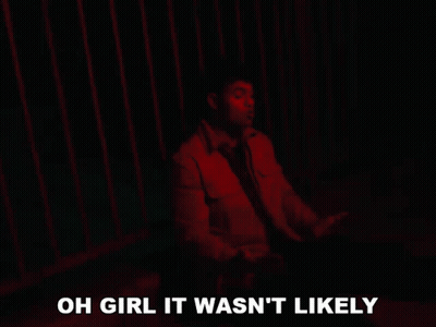 A Man Is Sitting In Front Of A Red Fence With The Words Oh Girl It Wasn 'T Likely Below Him GIF