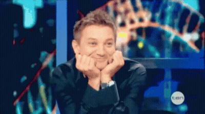 A Man Is Sitting In Front Of A Screen That Says Ten On It GIF