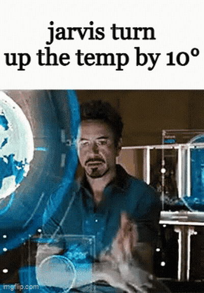 A Man Is Sitting In Front Of A Screen With The Words Jarvis Turn Up The Temp By 10 Degrees On It . GIF