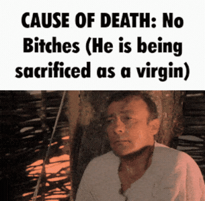 A Man Is Sitting In Front Of A Sign That Says Cause Of Death No Bitches ( He Is Being Sacrificed As A Virgin GIF