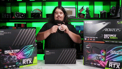 A Man Is Sitting In Front Of A Stack Of Aorus Gtx 1080 Ti Graphics Cards . GIF