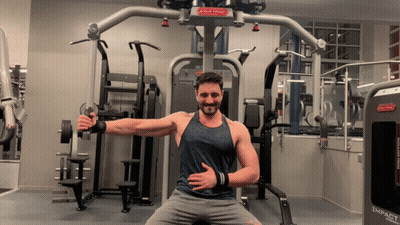 A Man Is Sitting In Front Of A Star Tracy Machine GIF