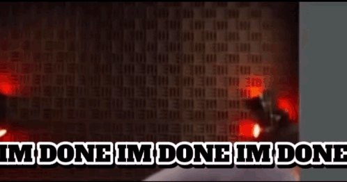 A Man Is Sitting In Front Of A Wall With The Words `` I 'M Done I 'M Done '' Written On It GIF