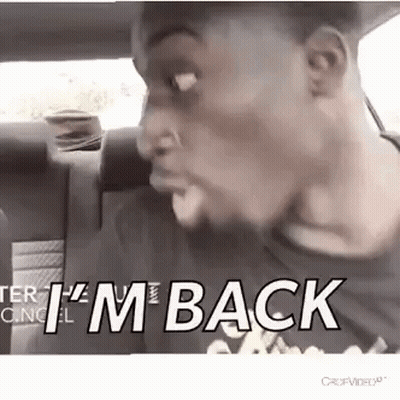 A Man Is Sitting In The Back Seat Of A Car And Making A Face . GIF