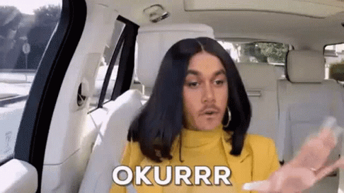 A Man Is Sitting In The Back Seat Of A Car With A Wig On . GIF