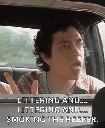 A Man Is Sitting In The Back Seat Of A Car With His Tongue Out And Smoking The Reefer . GIF