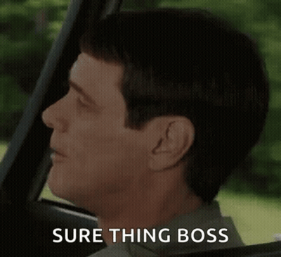 A Man Is Sitting In The Driver 'S Seat Of A Car Making A Funny Face And Saying `` Sure Thing Boss '' . GIF