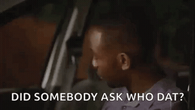 A Man Is Sitting In The Driver 'S Seat Of A Car . GIF