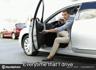 A Man Is Sitting In The Driver 'S Seat Of A Silver Car . GIF