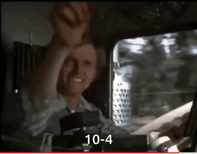 A Man Is Sitting In The Driver 'S Seat Of A Truck And Making A Face . GIF