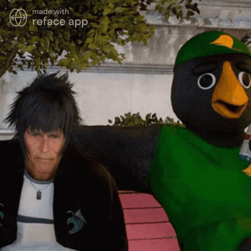 A Man Is Sitting Next To A Cartoon Bird With The Words Made With Reface App On The Bottom GIF
