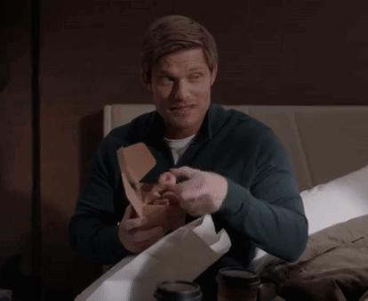 Man Sitting On Bed Holding Donut Box GIF