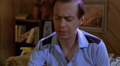 A Man Is Sitting On A Bed Looking At A Ring GIF